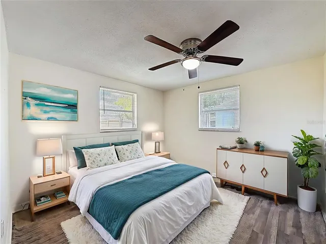 a bedroom with a bed and a potted plant