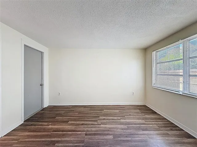 a view of room with window and wooden floor