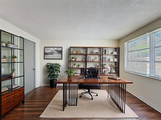 a living room with furniture a window and a potted plant