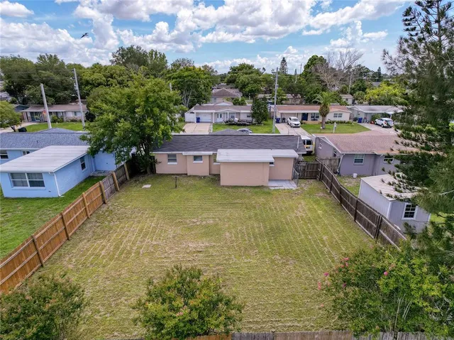 a view of a backyard with sitting area
