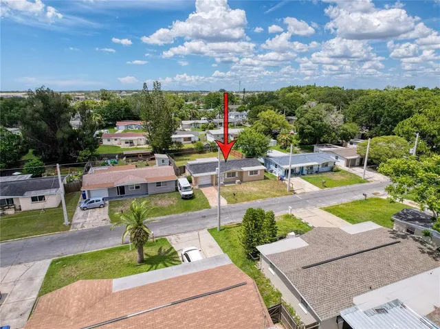 an aerial view of a house with a yard