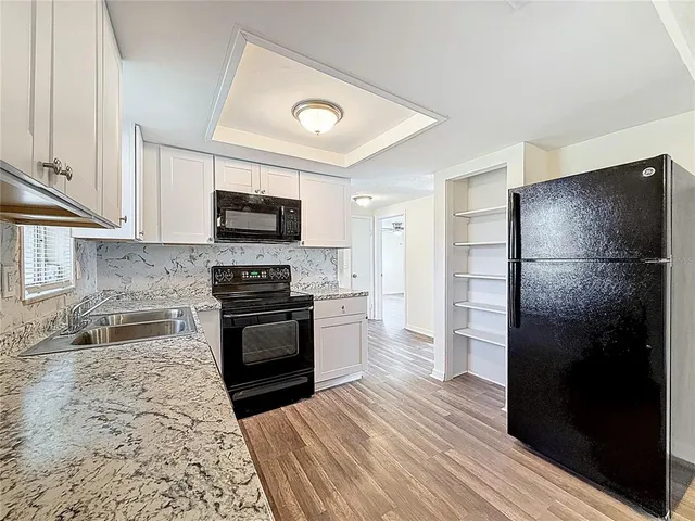 a kitchen with a refrigerator stove and microwave