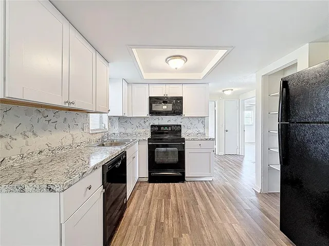 a kitchen with stainless steel appliances granite countertop a stove and a refrigerator