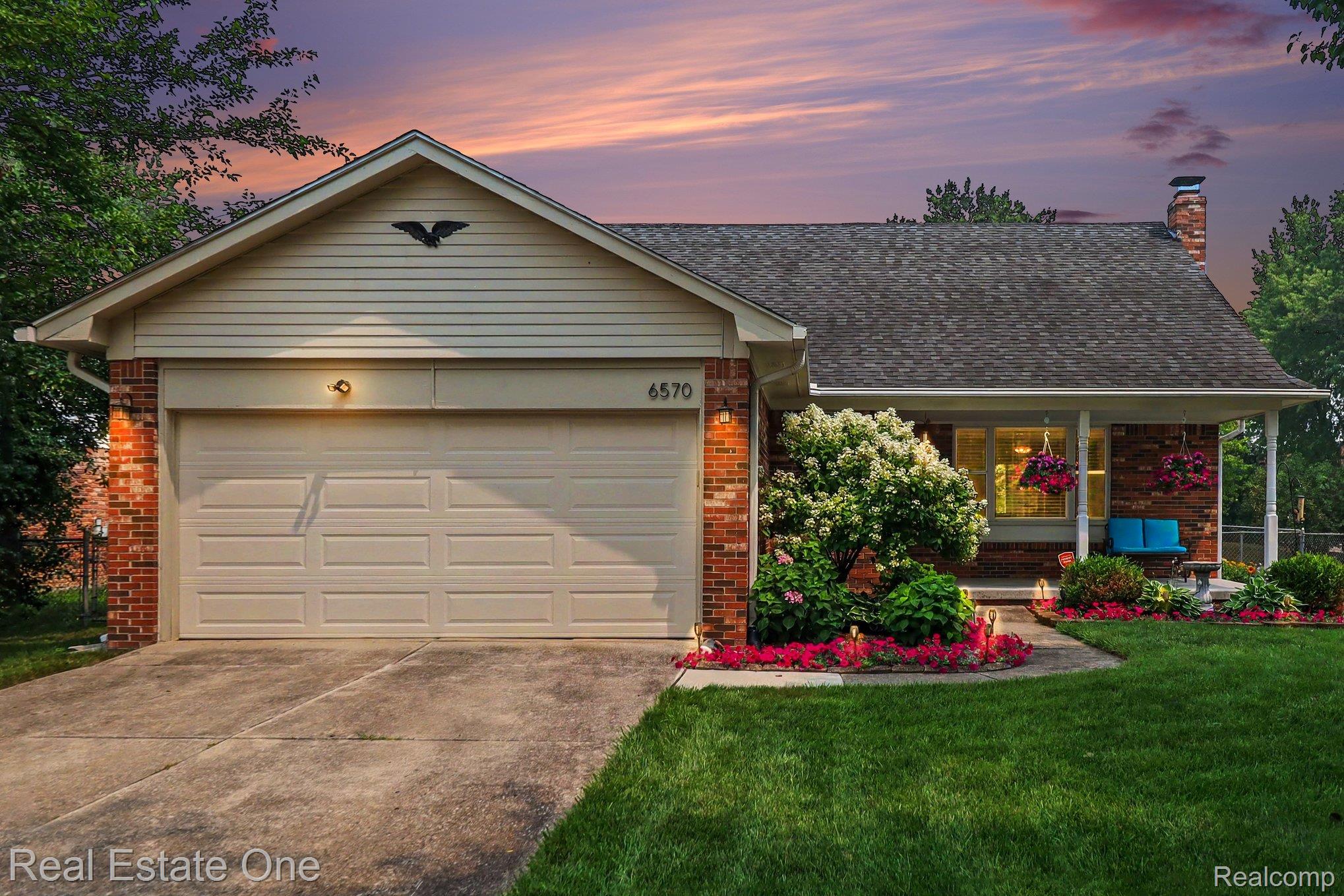 Brick exterior with light-colored siding accents and an attached two-car garage