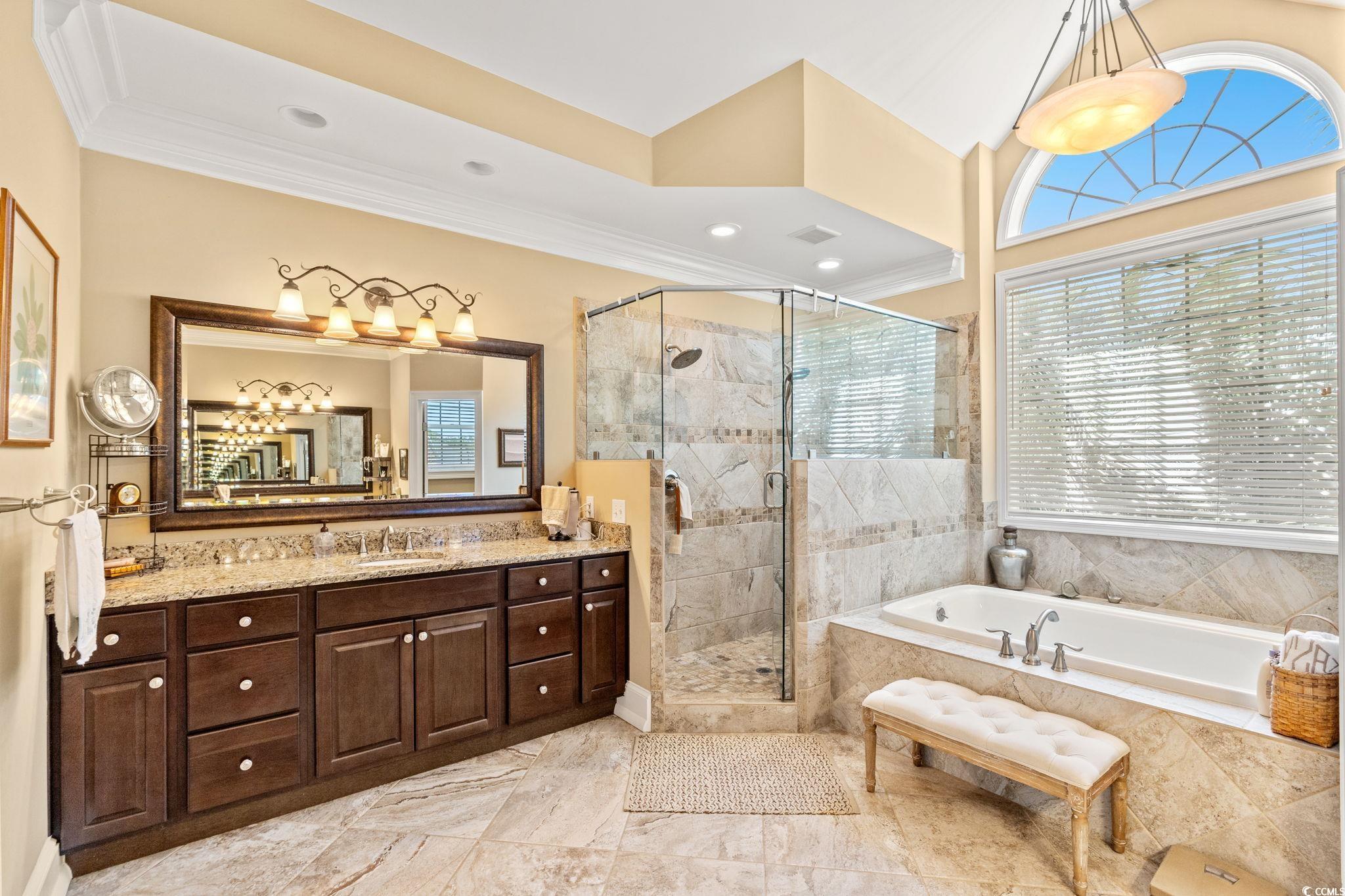 1119 Links Road Myrtle Beach, SC 29575 - Photo 25 of 40 Bathroom featuring a garden tub, vanity, a stall s