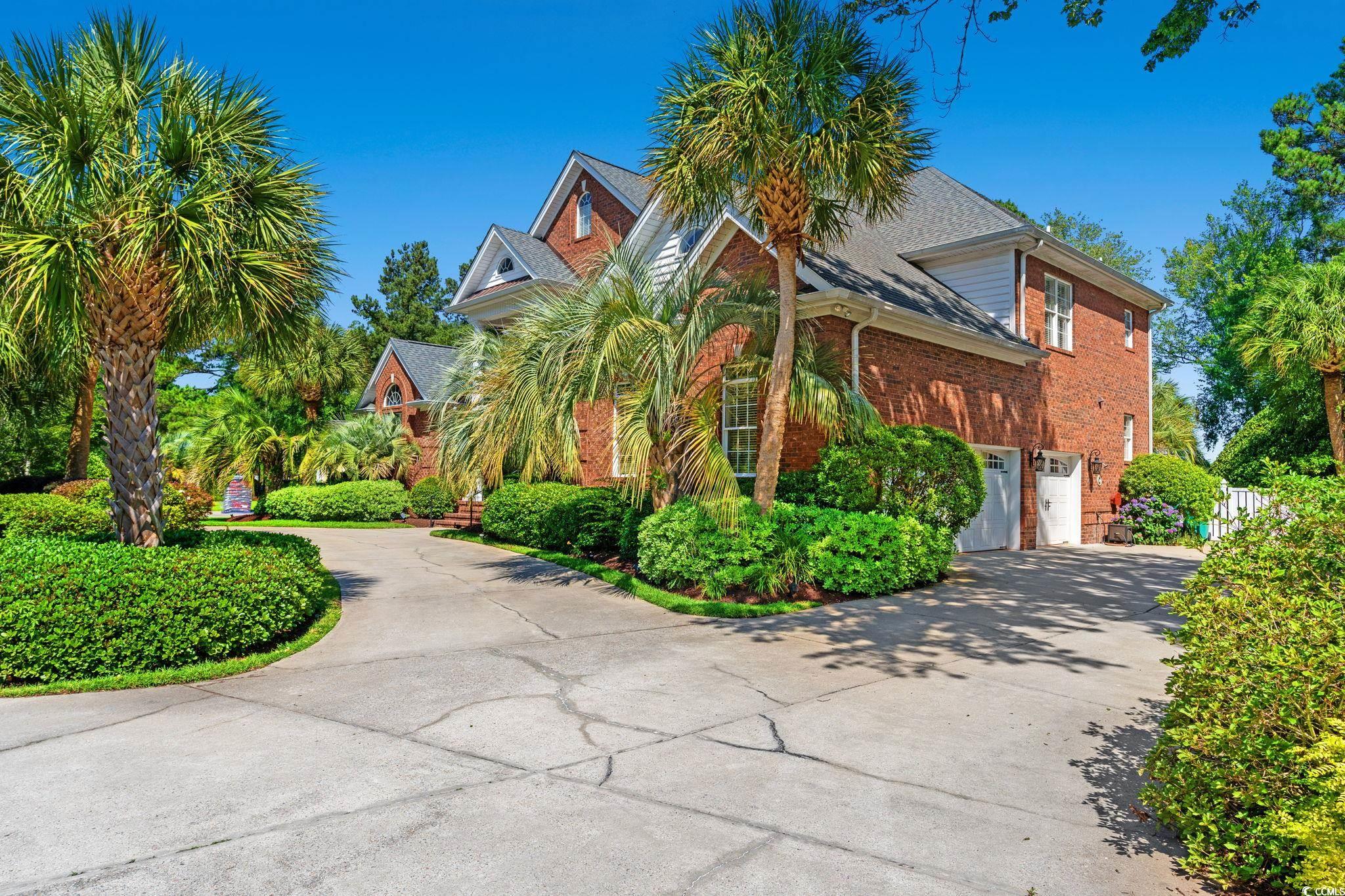 View of front of house with driveway, brick siding