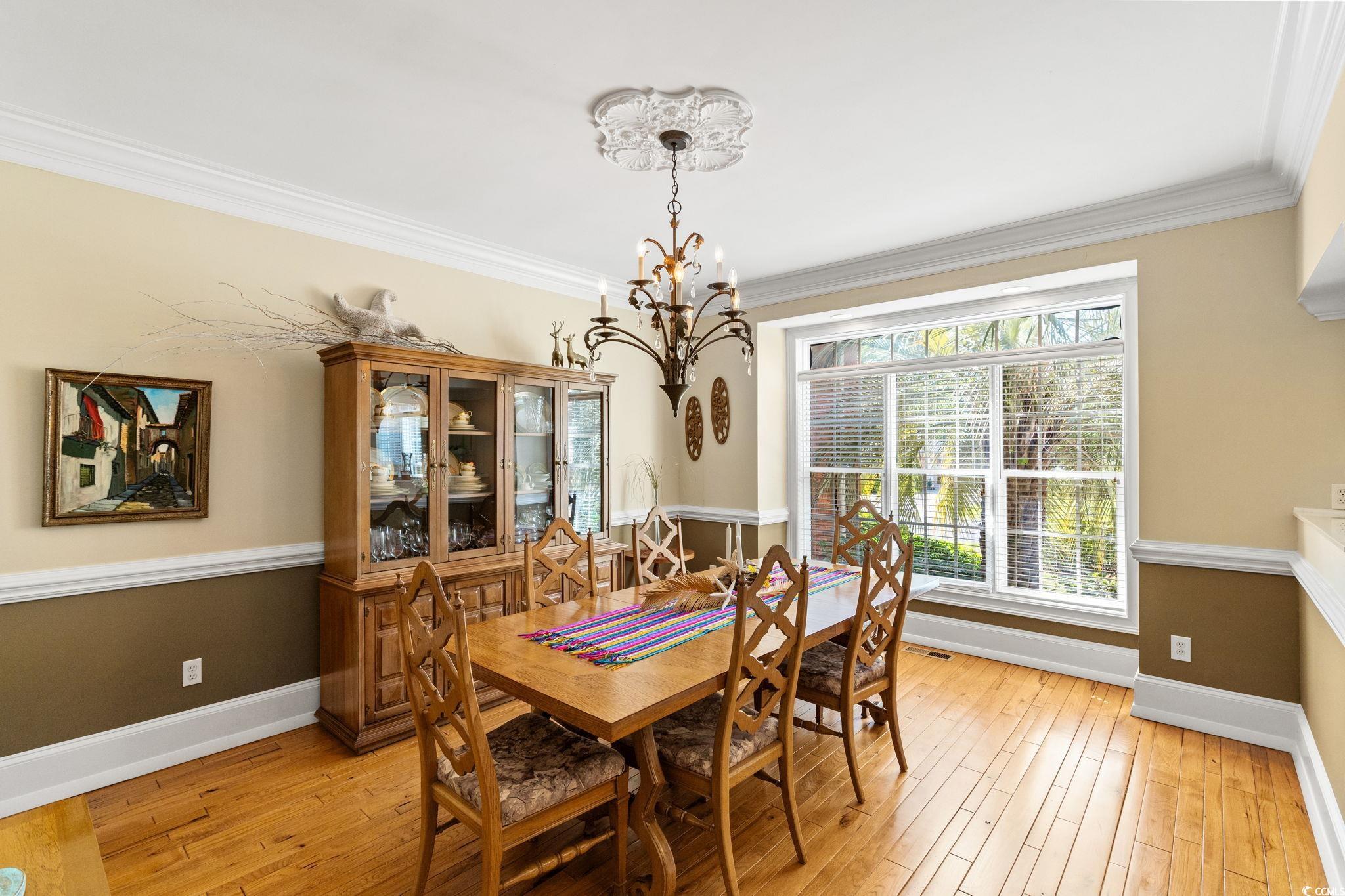 Dining area with a chandelier, baseboards, light w