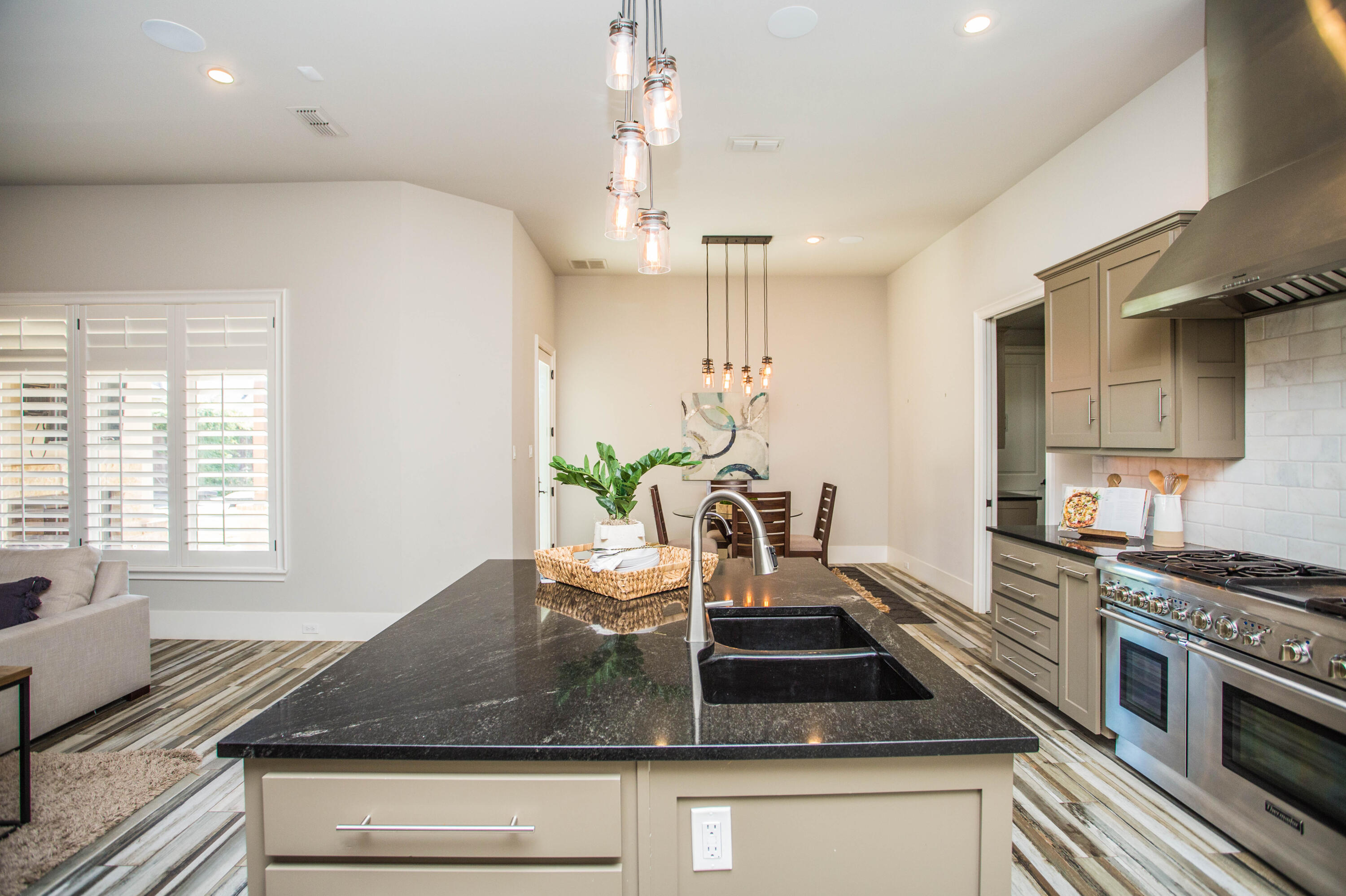 4807 116th Street Lubbock, TX 79424 - Photo 15 of 51 a kitchen with kitchen island granite countertop a sink appliances cabinets and a counter top space