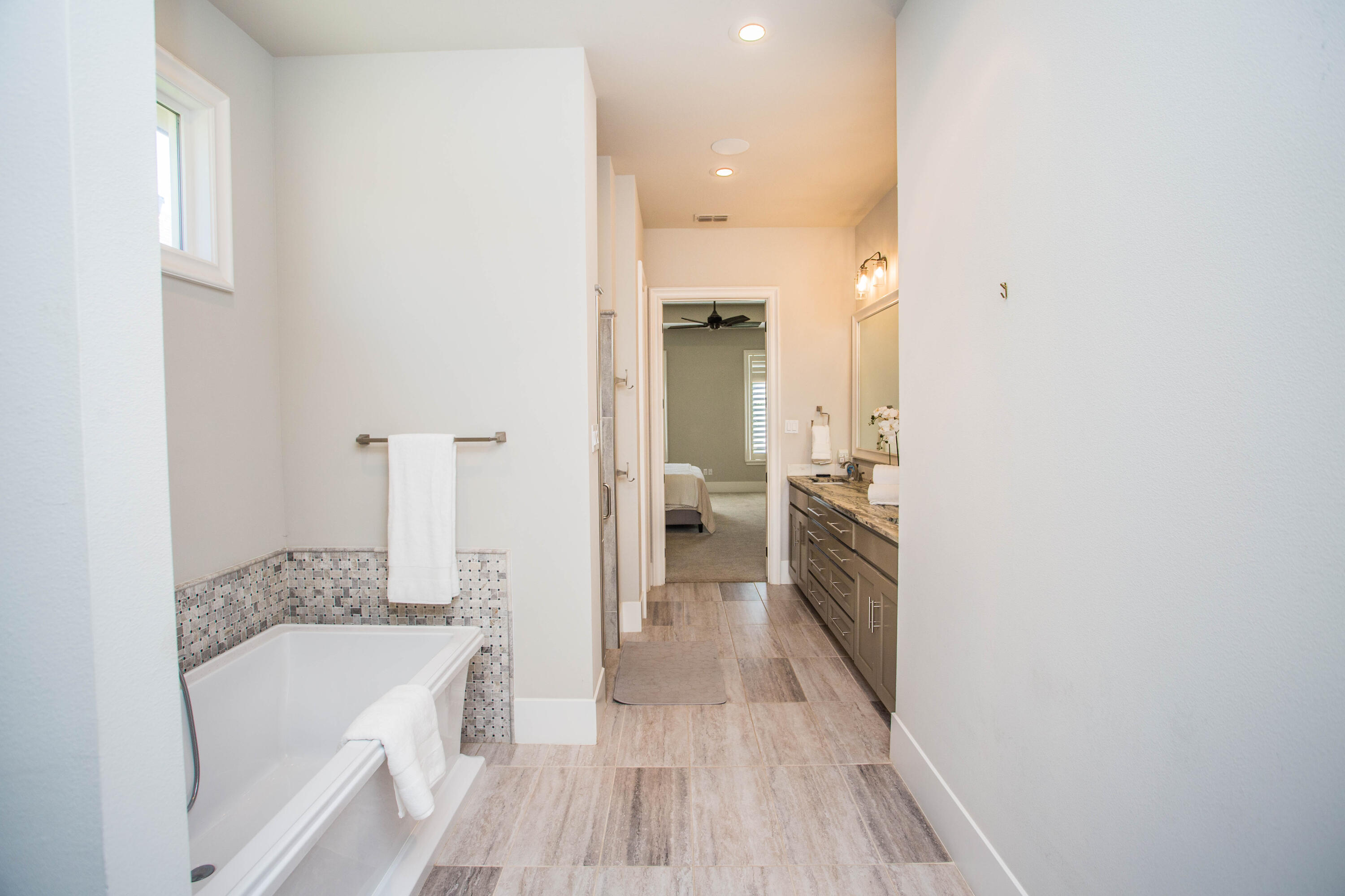 4807 116th Street Lubbock, TX 79424 - Photo 29 of 51 a bathroom with a tub sink and mirror