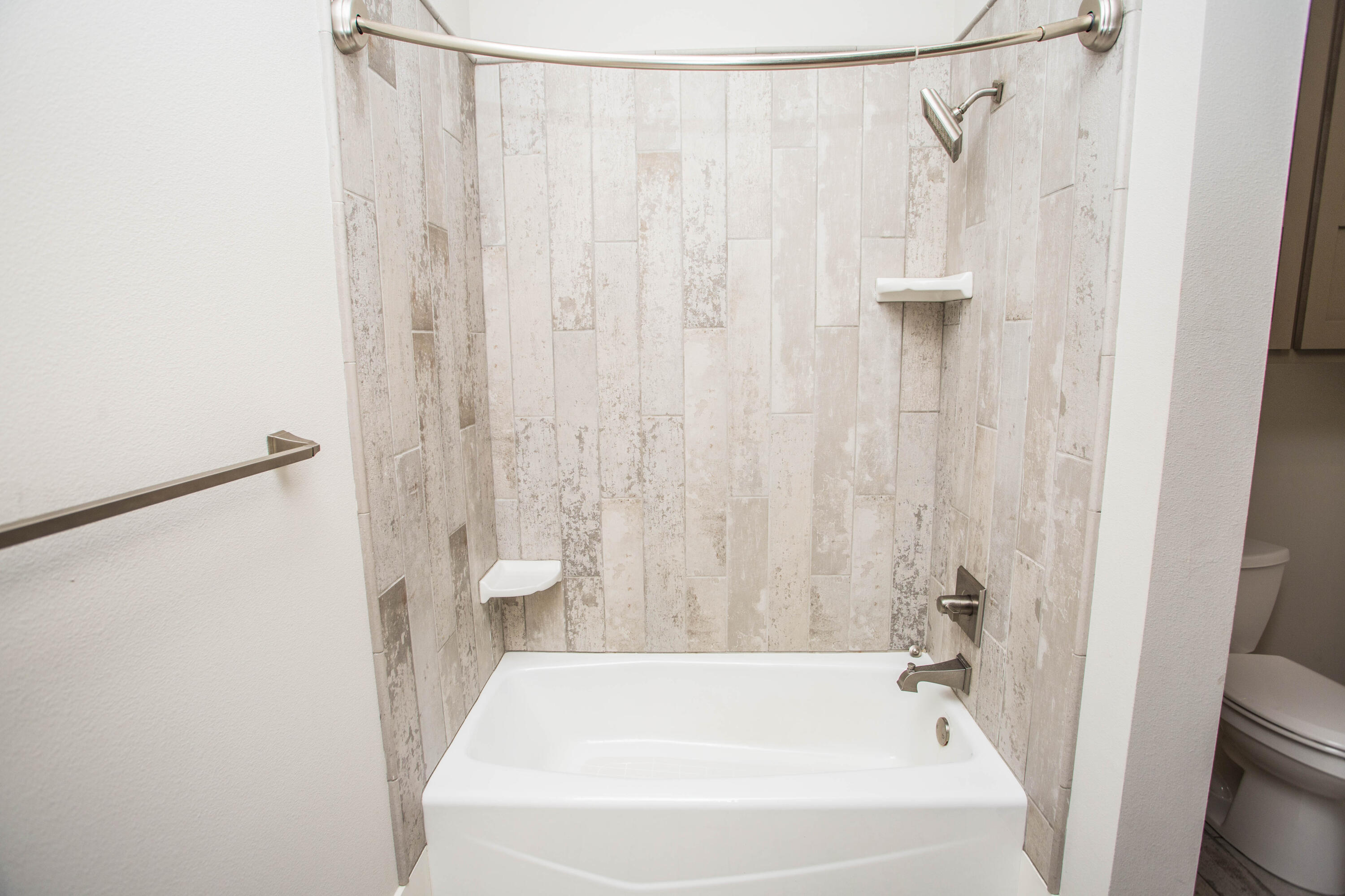 4807 116th Street Lubbock, TX 79424 - Photo 36 of 51 a white bath tub with a shower curtain
