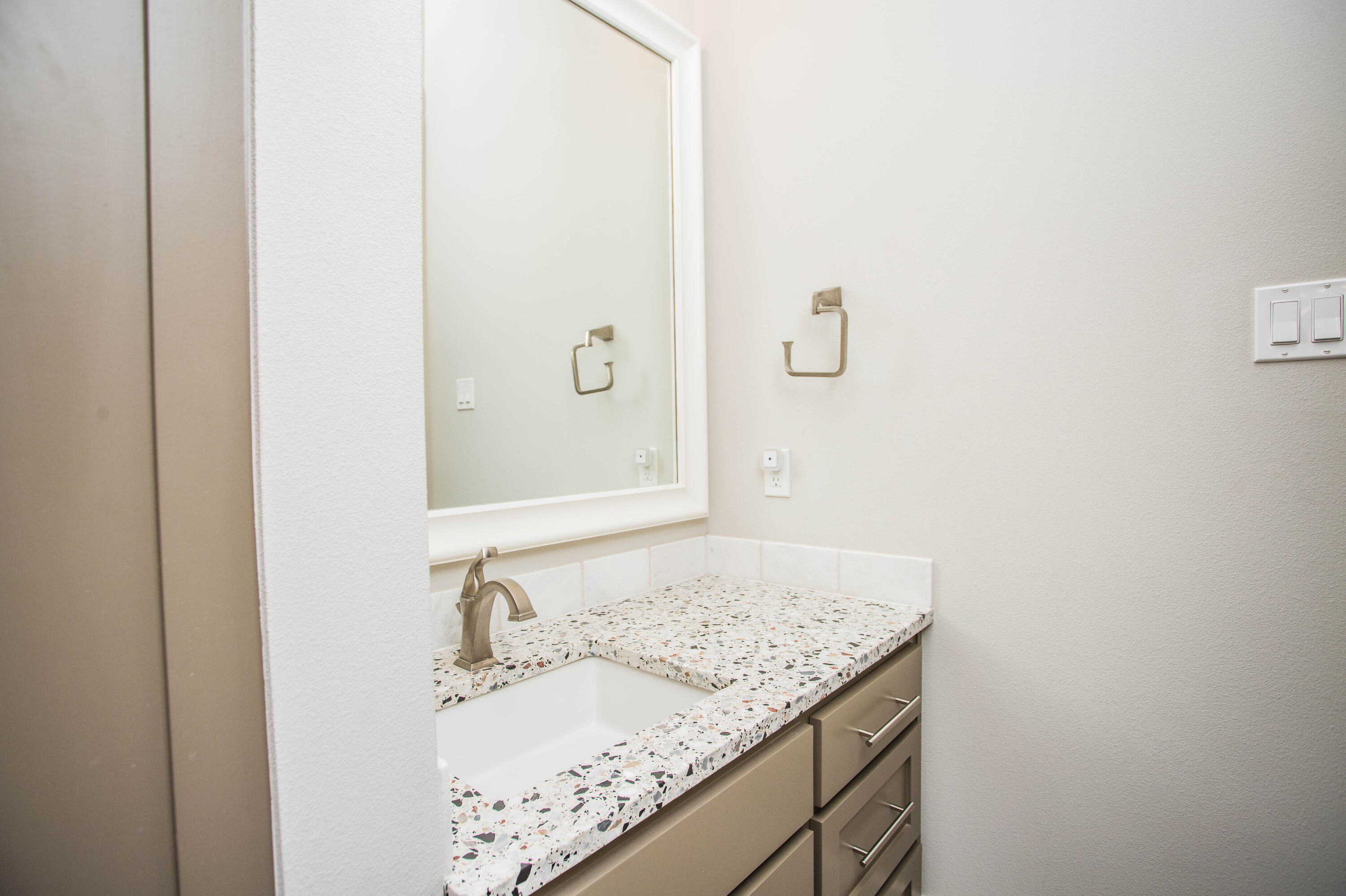 4807 116th Street Lubbock, TX 79424 - Photo 37 of 51 a bathroom with a granite countertop sink and mirror