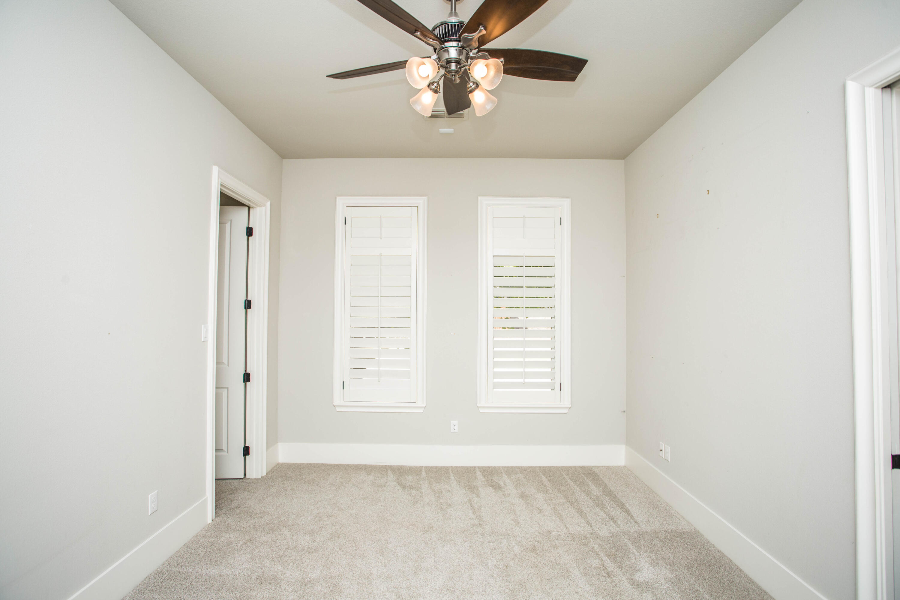 4807 116th Street Lubbock, TX 79424 - Photo 38 of 51 an empty room with windows and fan