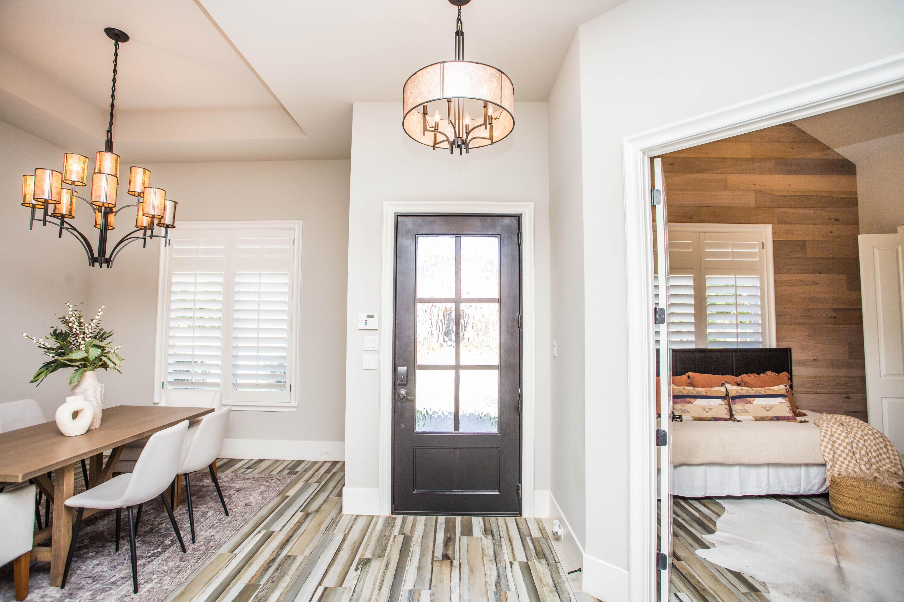4807 116th Street Lubbock, TX 79424 - Photo 4 of 51 a dining room with wooden floor a chandelier a wooden table and chairs