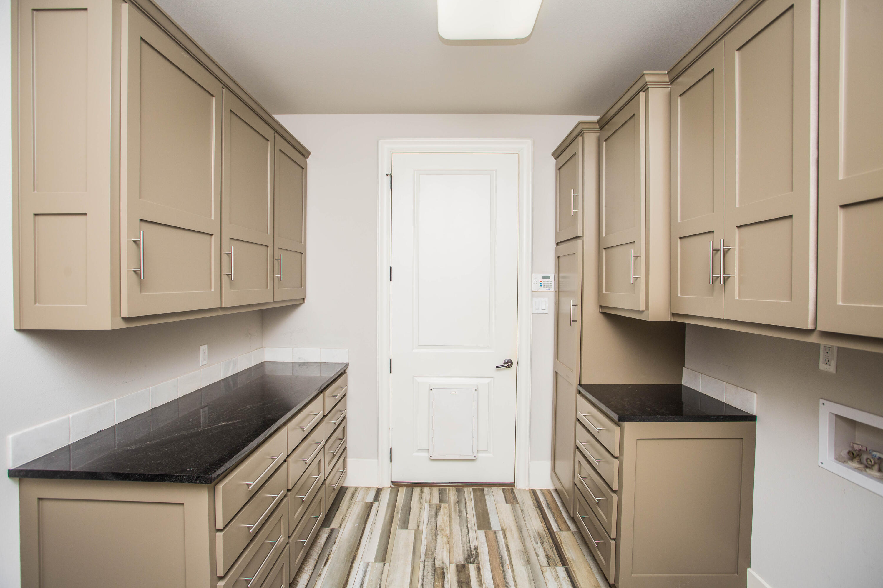 4807 116th Street Lubbock, TX 79424 - Photo 42 of 51 a kitchen with cabinets and a wooden floors