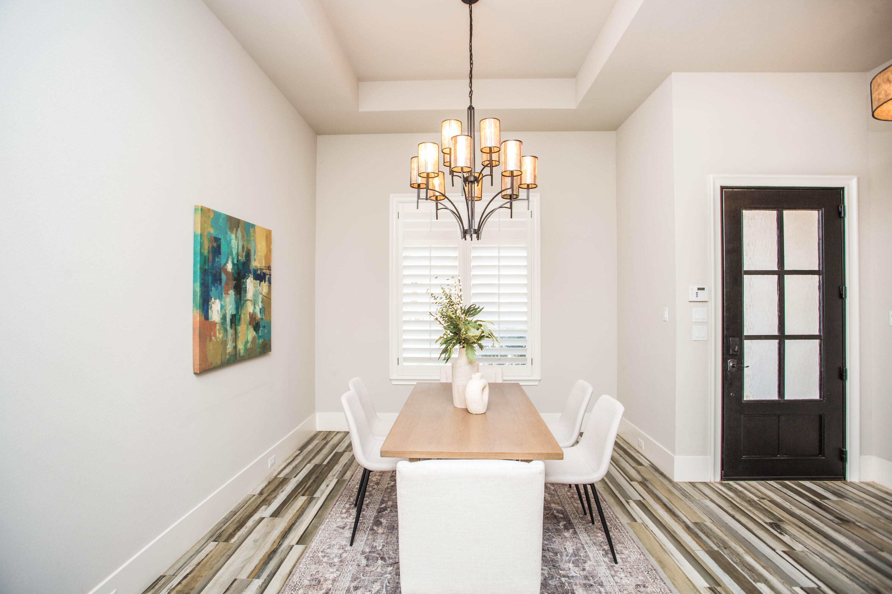 4807 116th Street Lubbock, TX 79424 - Photo 6 of 51 a view of a dining room with furniture a chandelier and wooden floor