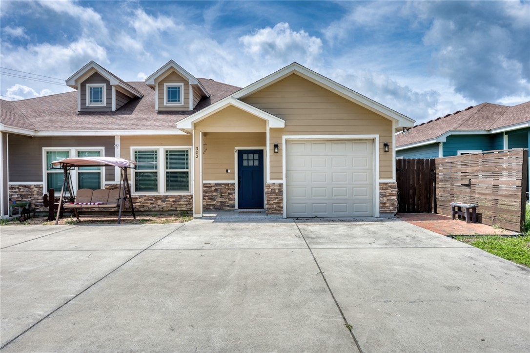 a front view of a house with yard and a garage