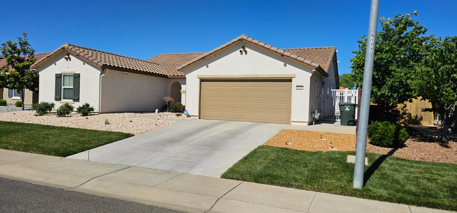 9290 Brock Court Live Oak, CA 95953 - Photo 4 of 29 a front view of a house with a yard and garage