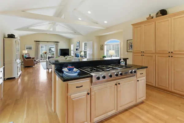 a kitchen with wooden cabinets and a stove