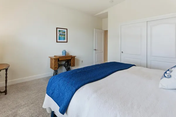 a bed room with a bed and a chair