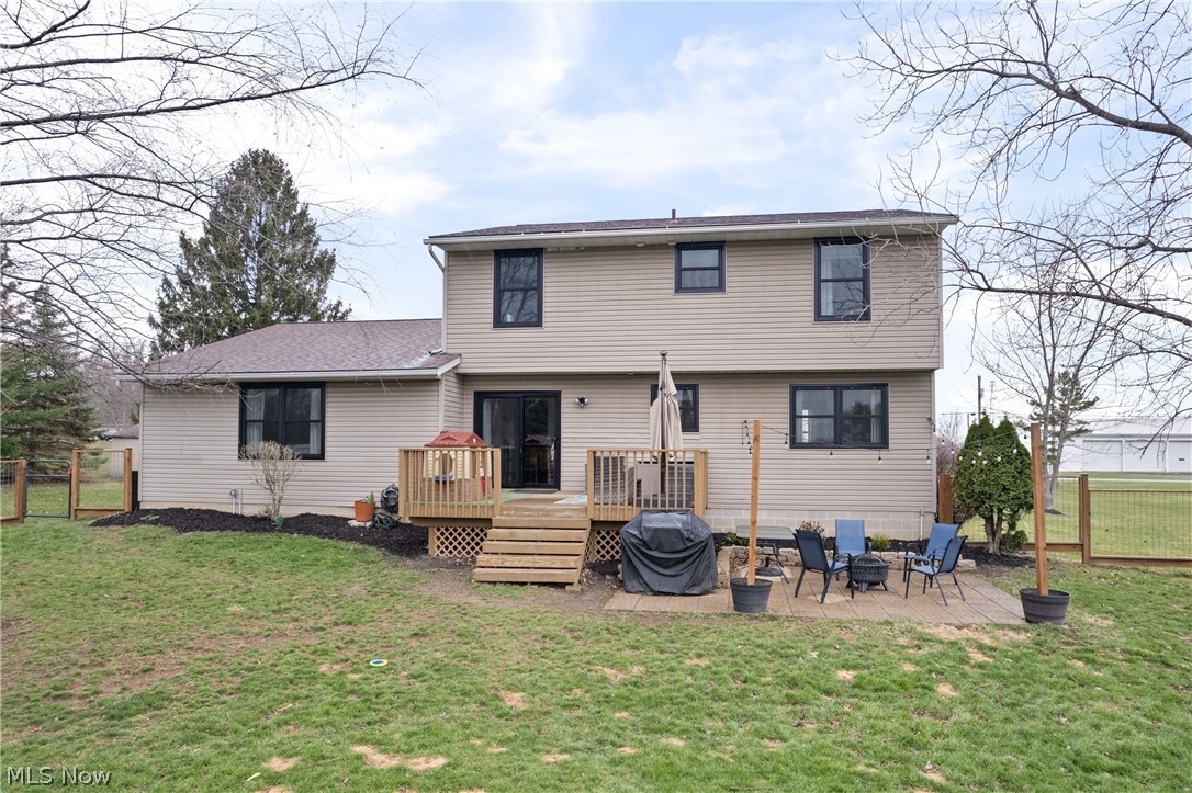 3969 Beat Road Litchfield, OH 44253 - Photo 26 of 31 Rear view of house featuring a wooden deck, and a patio area.