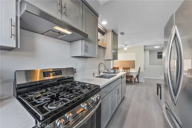 a kitchen with stainless steel appliances granite countertop a stove and a refrigerator