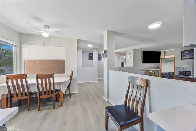 a view of a dining room with furniture and a flat screen tv