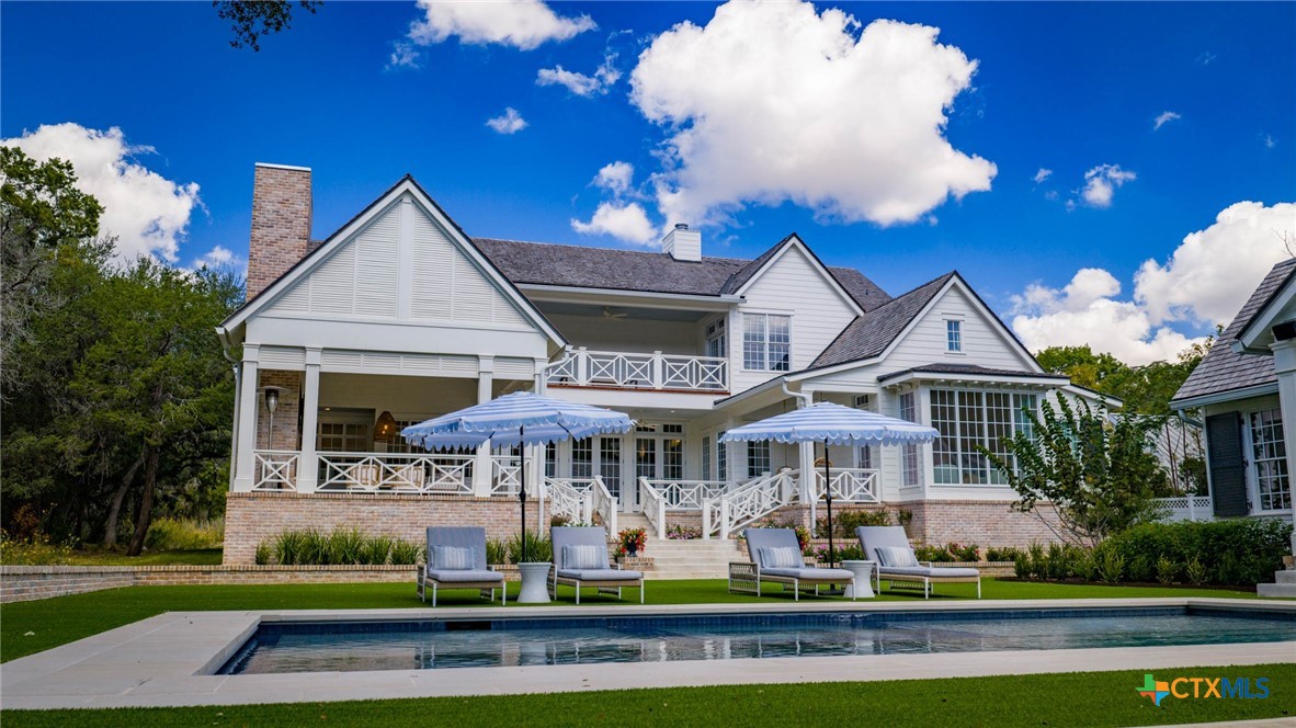 1755 Riada Drive New Braunfels, TX 78132 - Photo 2 of 48 a front view of a house with swimming pool and trees