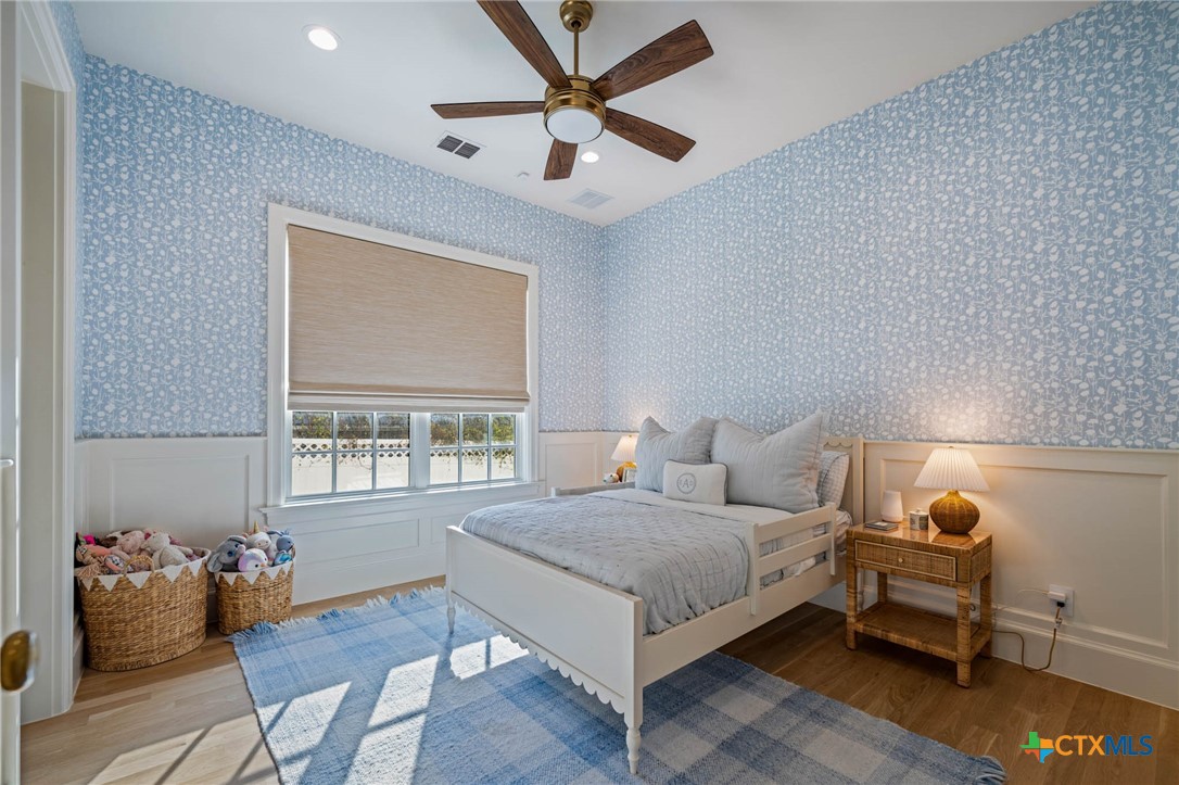 1755 Riada Drive New Braunfels, TX 78132 - Photo 21 of 48 a bedroom with a bed and wooden floor