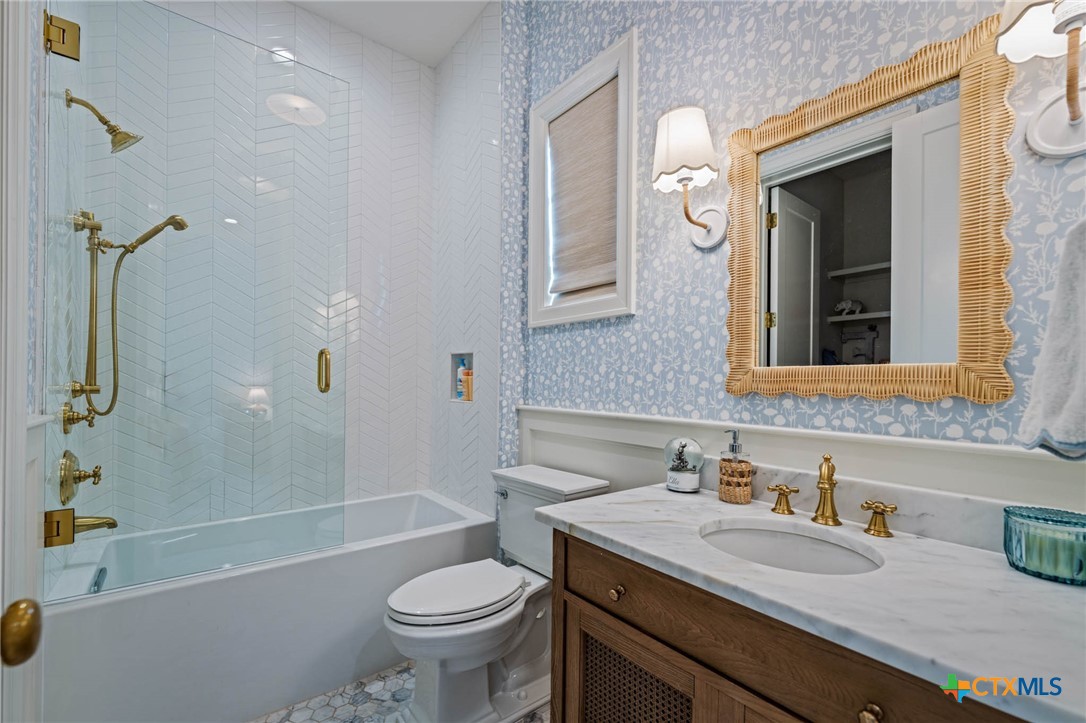 1755 Riada Drive New Braunfels, TX 78132 - Photo 22 of 48 a bathroom with a granite countertop sink toilet and shower