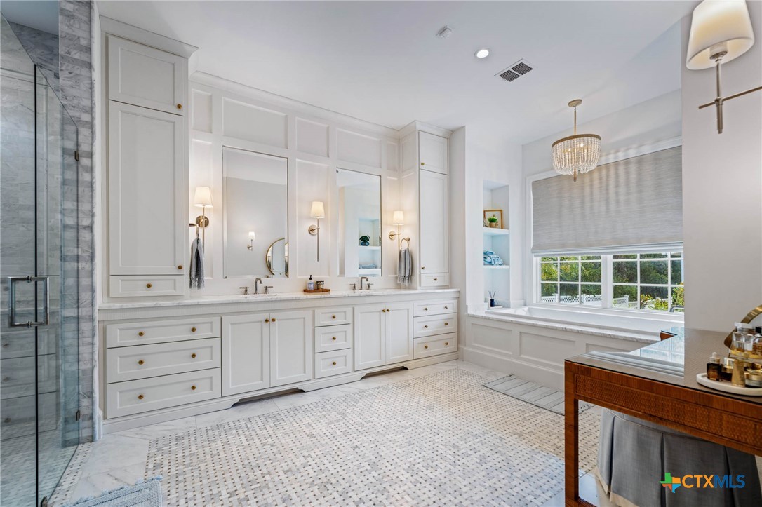 1755 Riada Drive New Braunfels, TX 78132 - Photo 28 of 48 a spacious bathroom with double vanity and a mirror