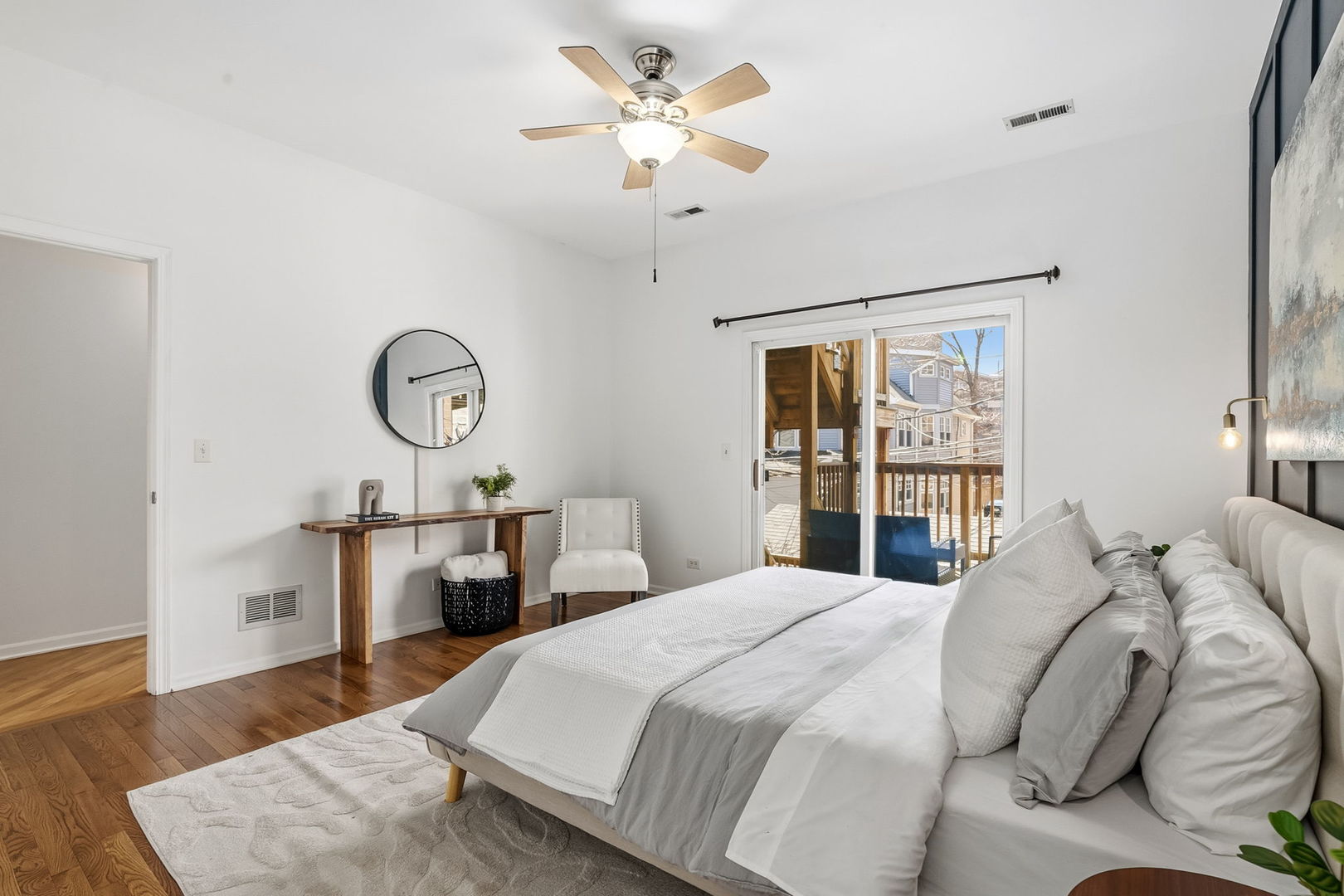 909 West Roscoe Street, Unit 2 Chicago, IL 60657 - Photo 12 of 22 a bedroom with a bed a chandelier and a window