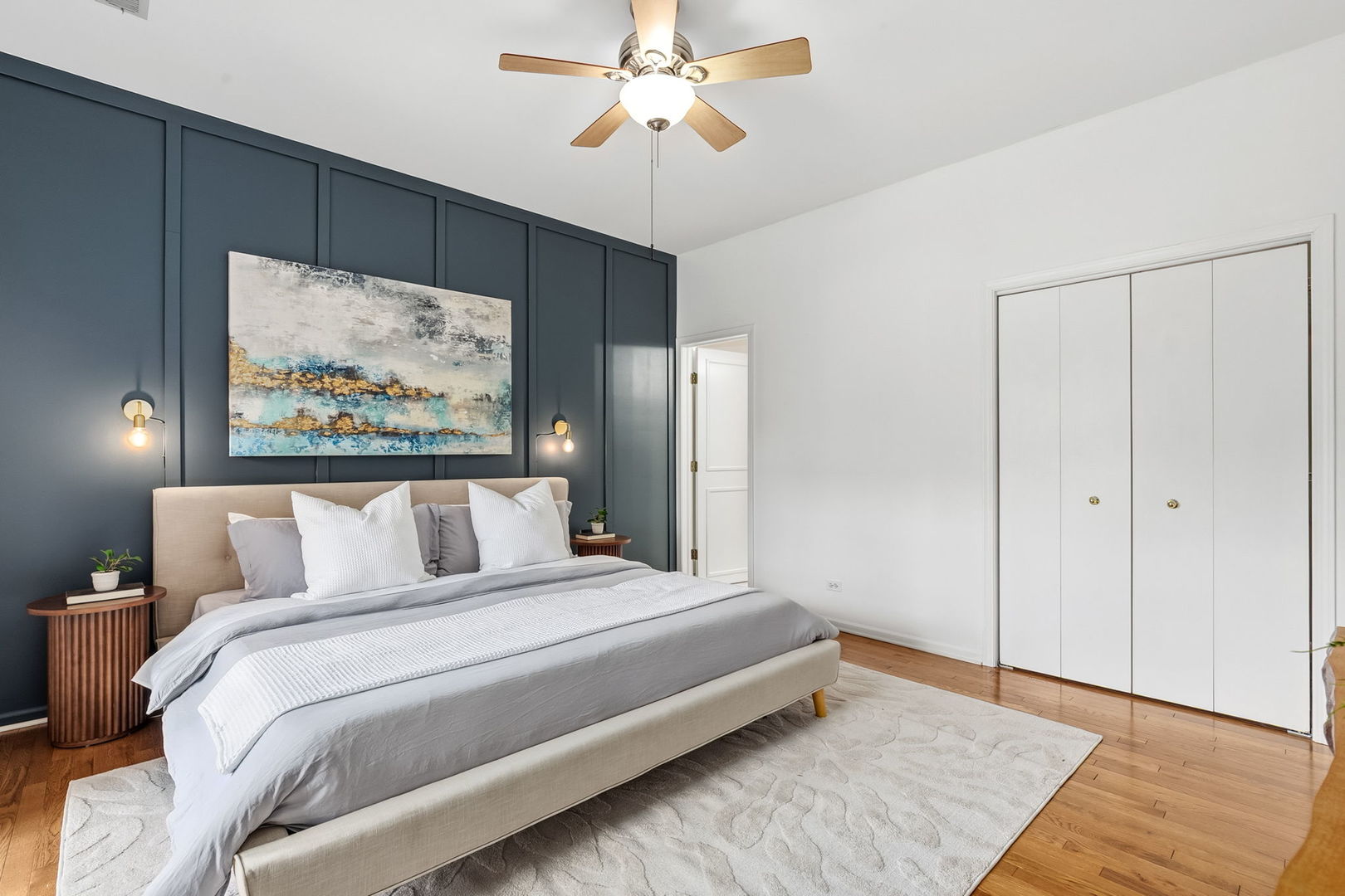 909 West Roscoe Street, Unit 2 Chicago, IL 60657 - Photo 13 of 22 a bedroom with a large bed and a chandelier