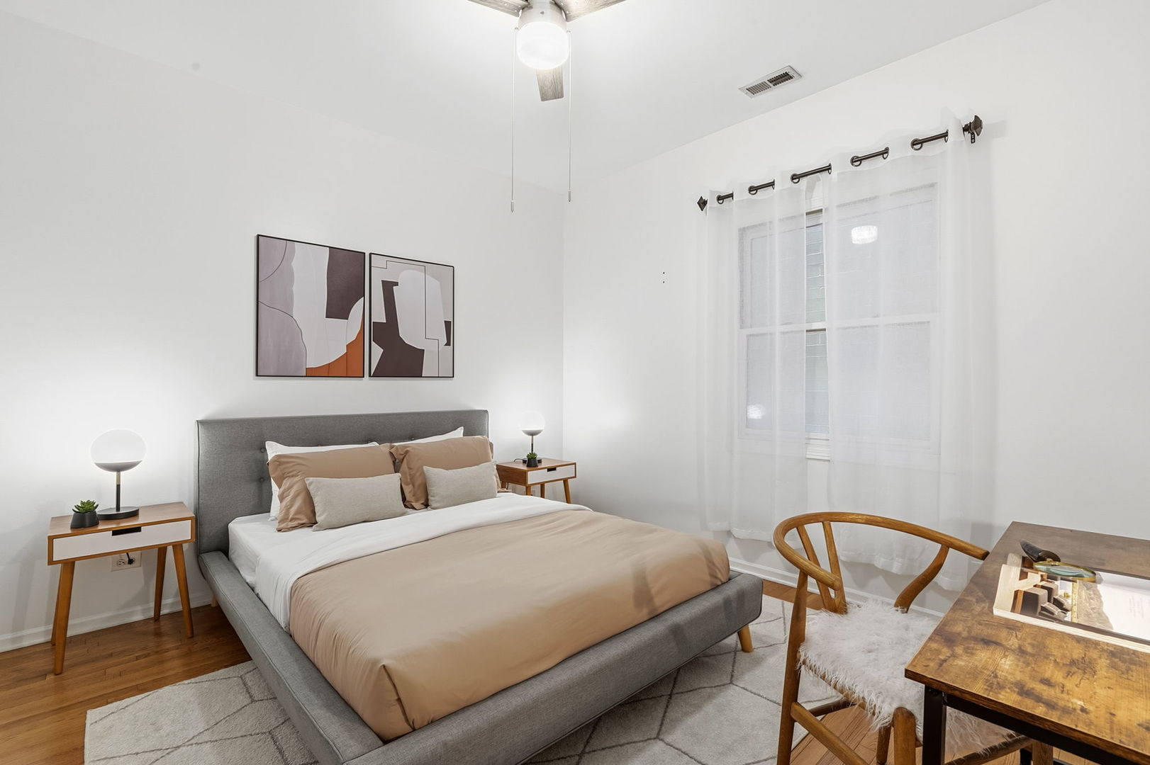 909 West Roscoe Street, Unit 2 Chicago, IL 60657 - Photo 16 of 22 a bedroom with a bed and a table