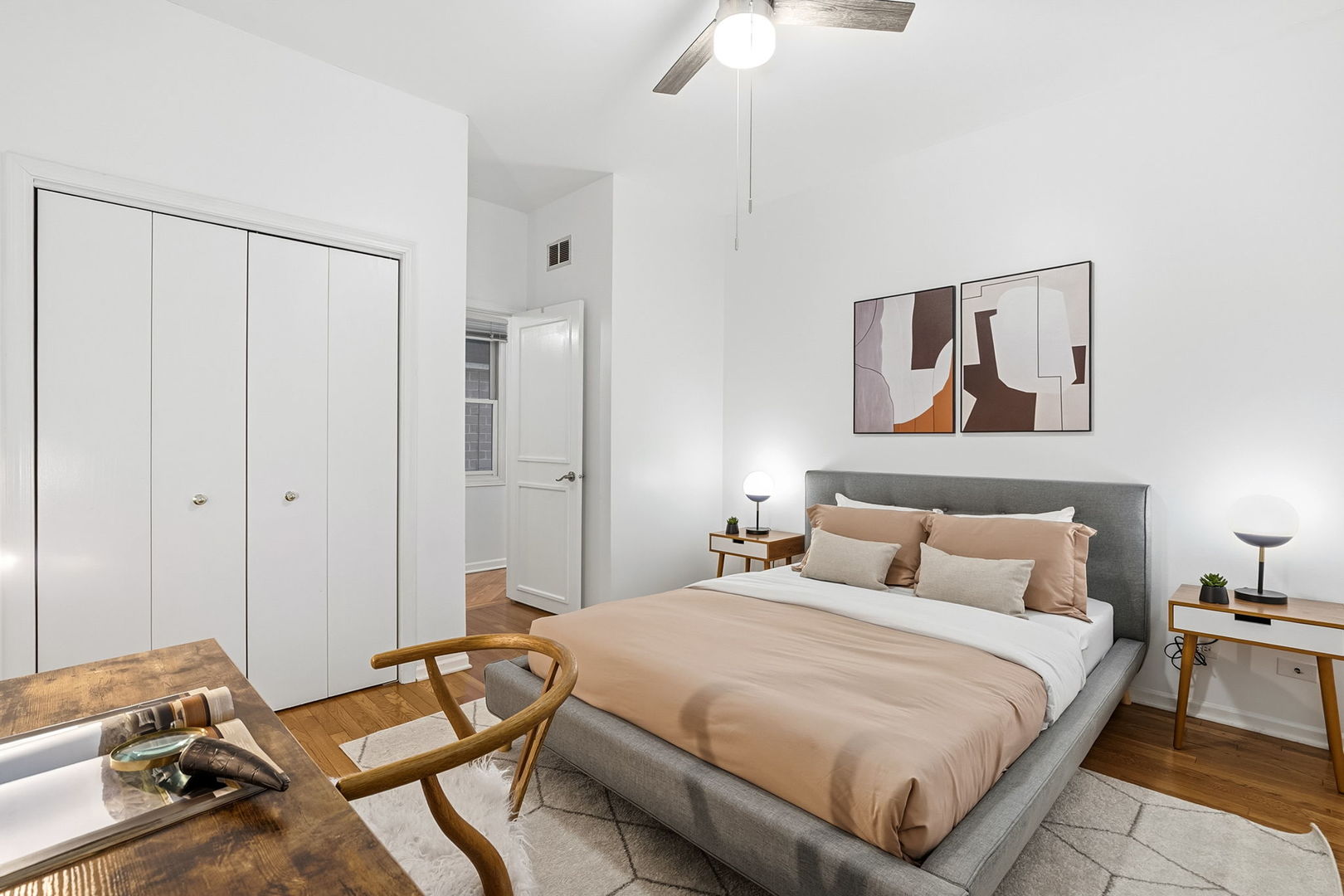 909 West Roscoe Street, Unit 2 Chicago, IL 60657 - Photo 17 of 22 a bedroom with a bed and wooden floor