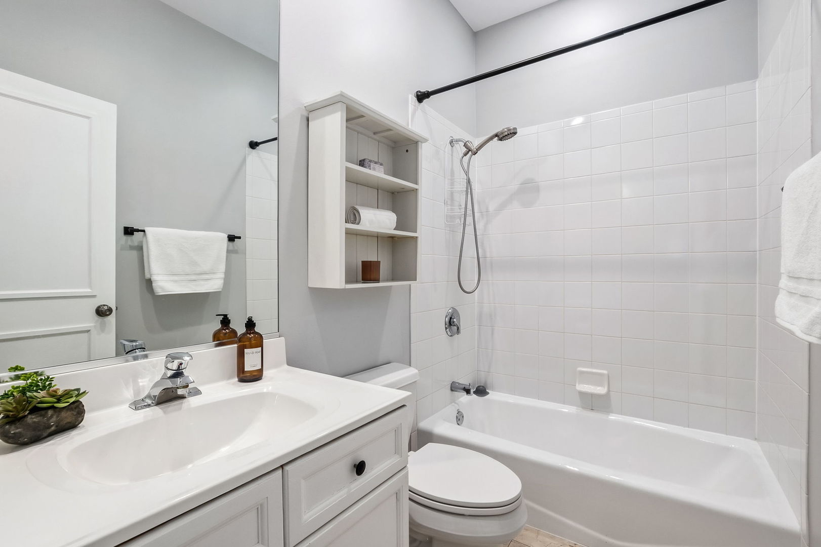 909 West Roscoe Street, Unit 2 Chicago, IL 60657 - Photo 18 of 22 a bathroom with a sink toilet tub vanity and shower