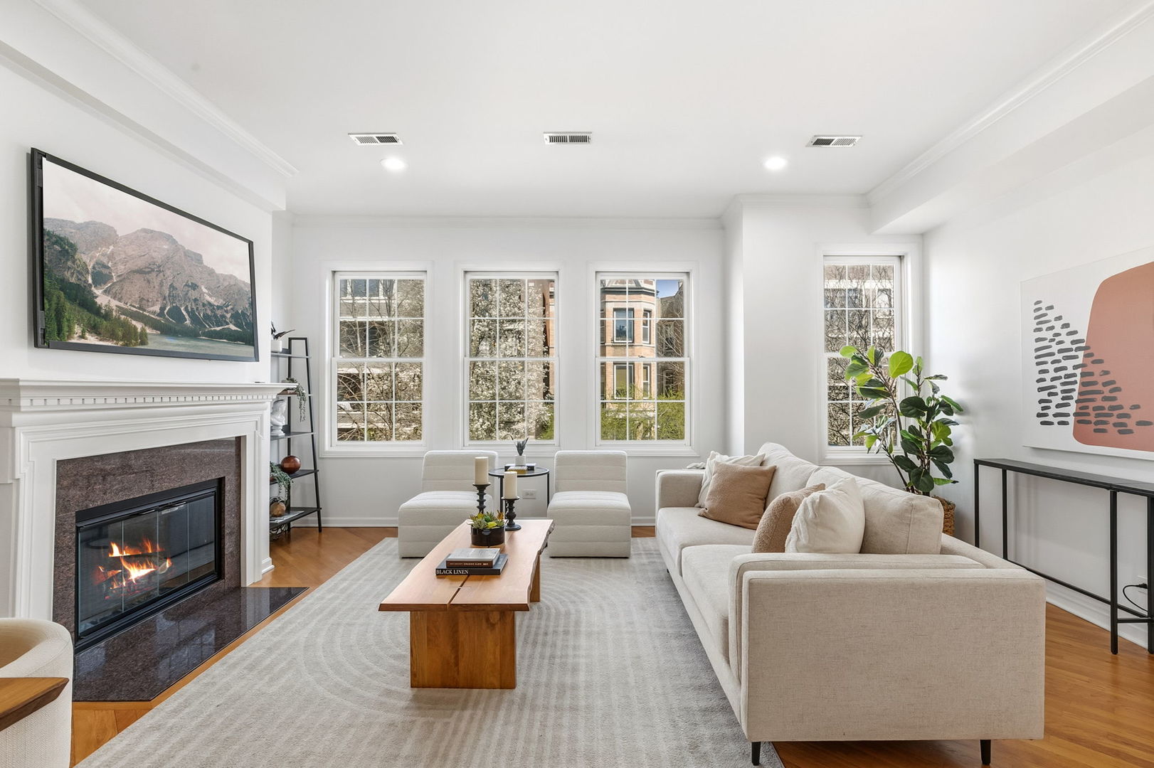 909 West Roscoe Street, Unit 2 Chicago, IL 60657 - Photo 2 of 22 a living room with furniture a large window and a fireplace