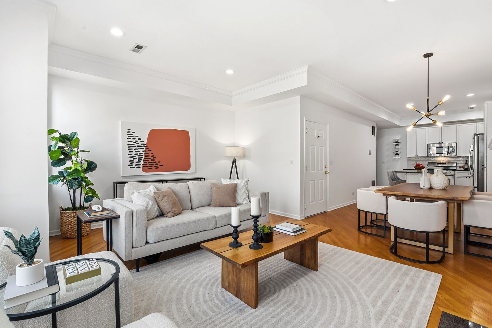 909 West Roscoe Street, Unit 2 Chicago, IL 60657 - Photo 5 of 22 a living room with furniture and a chandelier