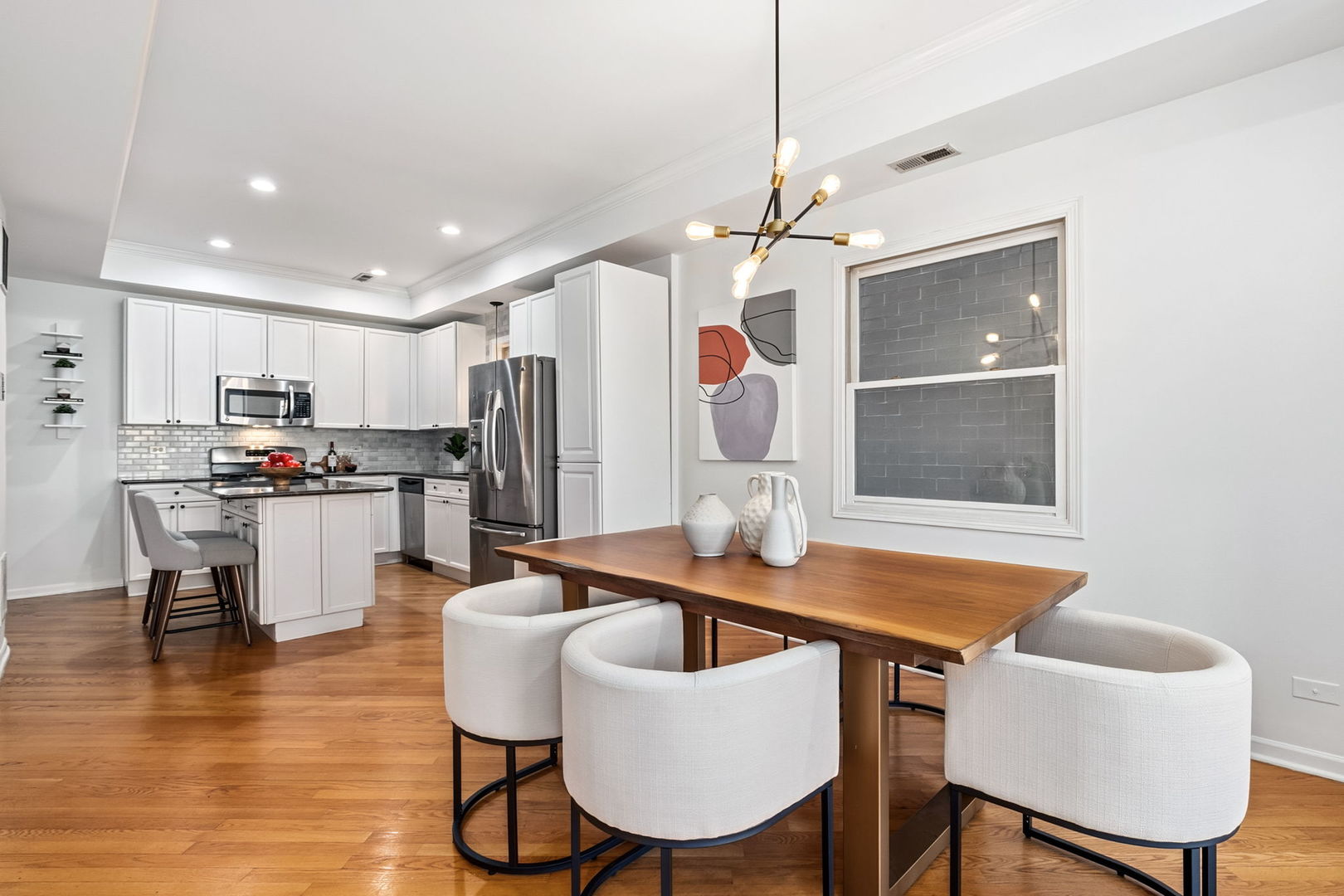 909 West Roscoe Street, Unit 2 Chicago, IL 60657 - Photo 6 of 22 a view of kitchen with furniture and wooden floor