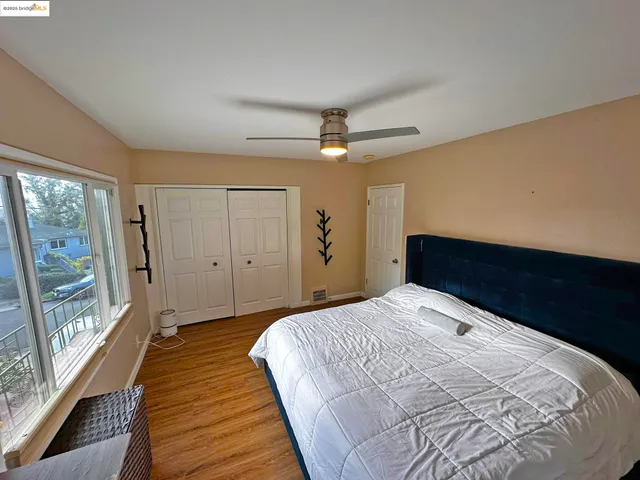 a bedroom with a large bed and a large window