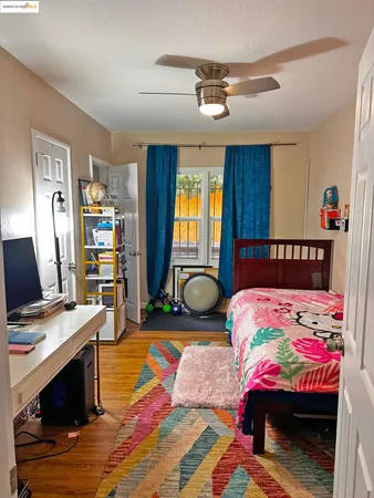 a bedroom with a bed and a desk