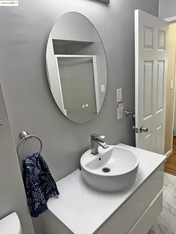 a bathroom with a sink a mirror and a toilet