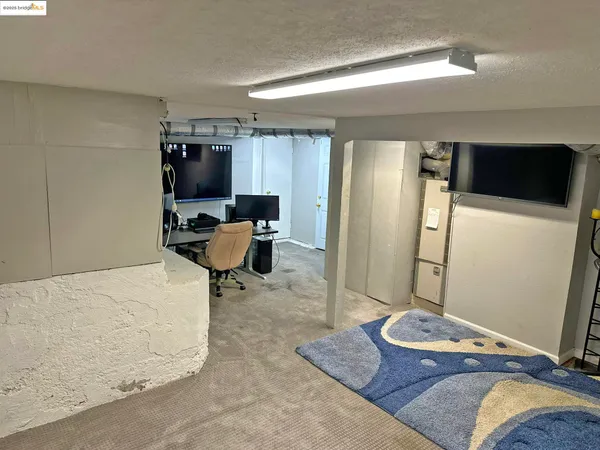 a bedroom with a bed and a television
