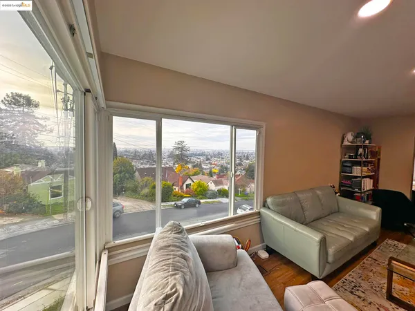 a living room with furniture and a floor to ceiling window