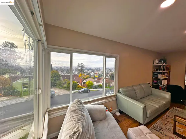 a living room with furniture and a floor to ceiling window