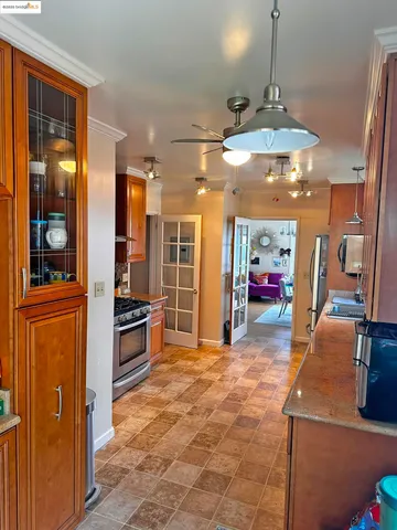 a view of a kitchen with a sink a refrigerator and cabinets
