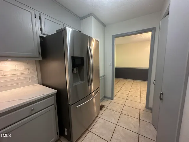 a kitchen with metallic refrigerator freezer and a dishwasher