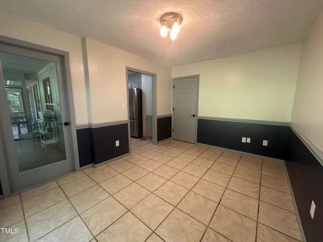 a room with a bed and mirror