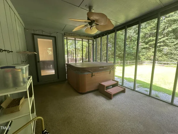 a living room with furniture and a floor to ceiling window