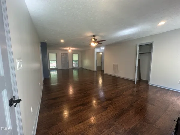 wooden floor in an empty room with a mirror