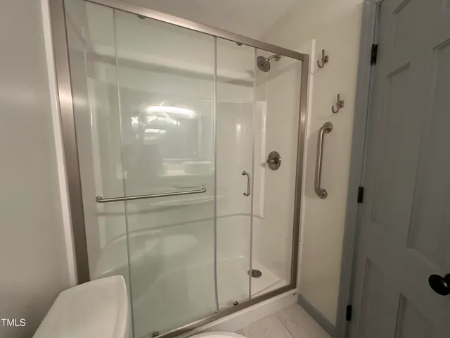 a bathroom with a glass shower door